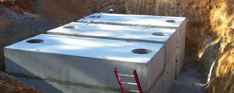 Septic tank installation site with a newly placed concrete tank in Aurora, CO